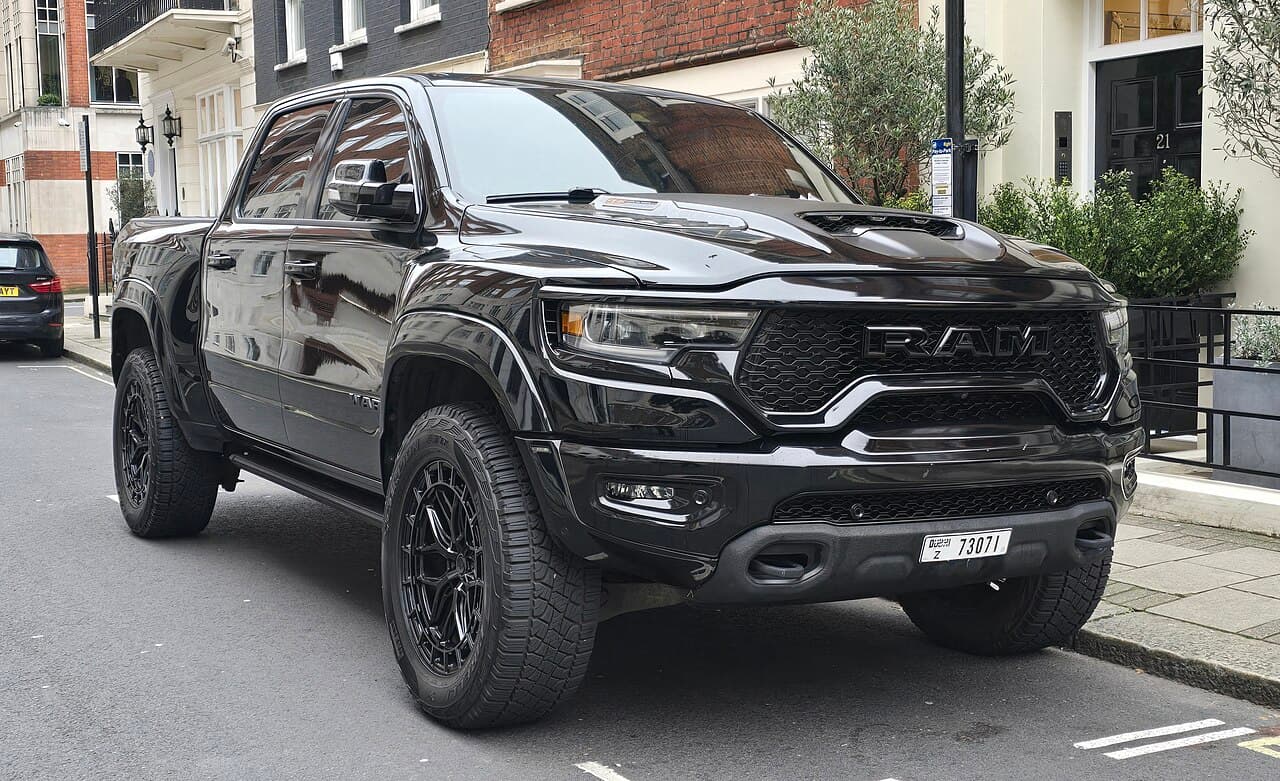 Front three-quarter view of a black Ram 1500 TRX parked on a residential street in London, UK.