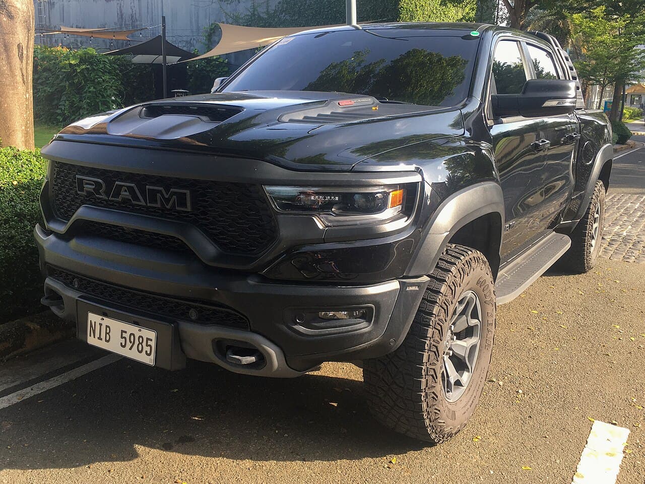 Front three-quarter view of a black Ram 1500 TRX parked on a street in Muntinlupa, Metro Manila, Philippines.