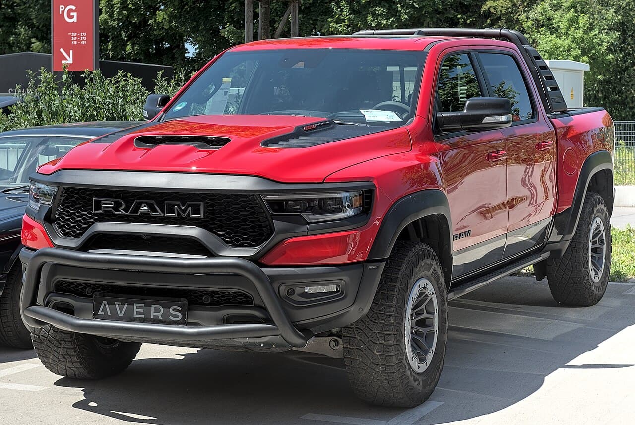 Front three-quarter view of a red Ram 1500 TRX fitted with an aftermarket bull bar, parked at MYLE Festival 2025.